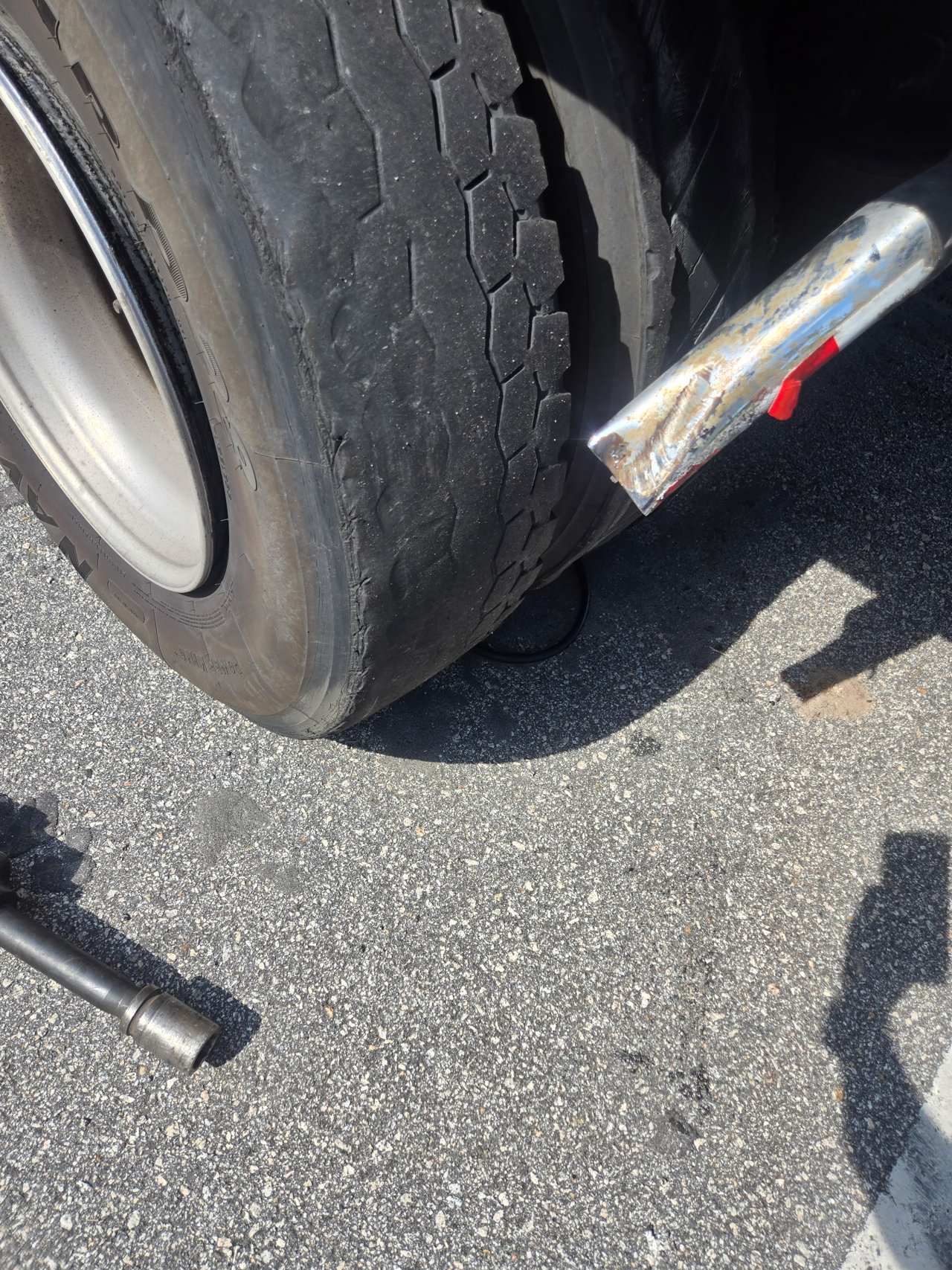 Outside semi-truck tire with blowout damage beside the interstate in Greensboro, Georgia.